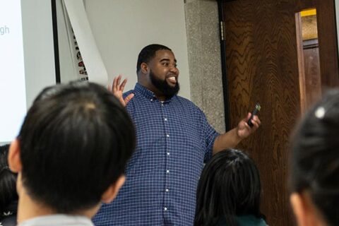 African American male teaching a college class